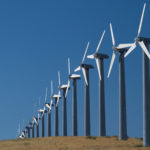 A row of wind turbines generating green energy.